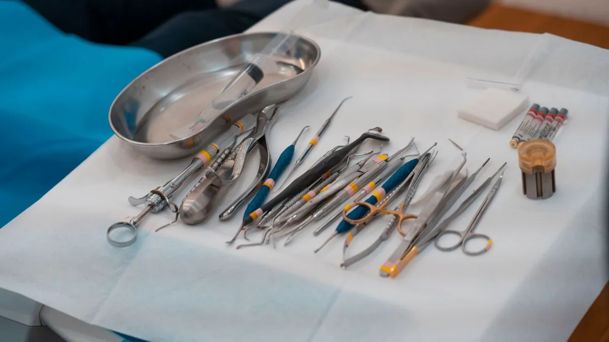 A neatly arranged set of dental tools on a sterile tray, showcasing essential medical instruments for dentistry.